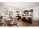 An open concept kitchen and dining area with stainless steel appliances and a central island with seating at 111 S Monroe St # B104, Denver, CO 80209