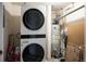 Convenient laundry area featuring a stacked washer/dryer and storage space at 111 S Monroe St # B104, Denver, CO 80209