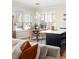 Cozy living room with a dining area, a central island, and natural light from large windows at 111 S Monroe St # B104, Denver, CO 80209