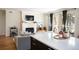 Inviting living room with a fireplace, balcony, and a view of the kitchen island at 111 S Monroe St # B104, Denver, CO 80209