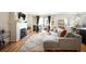 Well-lit living room with a fireplace, balcony, and comfortable seating arrangement at 111 S Monroe St # B104, Denver, CO 80209