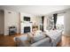 Cozy living room featuring a fireplace, balcony, and comfortable seating at 111 S Monroe St # B104, Denver, CO 80209