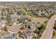 Community aerial view highlights neighborhood layout with mature trees, sidewalks, and open green spaces at 404 Yarrow Pl, Castle Pines, CO 80108