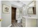 Well-lit bathroom featuring a vanity, framed mirror, and a tiled walk-in shower with glass doors and a patterned curtain at 404 Yarrow Pl, Castle Pines, CO 80108