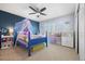 A bedroom with a blue accent wall, a window with shuttered blinds, and a ceiling fan for added comfort at 404 Yarrow Pl, Castle Pines, CO 80108