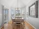 Charming dining room featuring a chandelier, hardwood floors, and ample natural light at 404 Yarrow Pl, Castle Pines, CO 80108