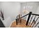 Two-story foyer with hardwood floors, a chandelier, and a staircase with dark wood banisters at 404 Yarrow Pl, Castle Pines, CO 80108