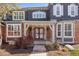 Inviting front porch with brick and wood accents, offering a warm welcome at 404 Yarrow Pl, Castle Pines, CO 80108