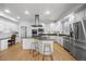 Bright kitchen includes stainless steel appliances, a center island, and custom cabinetry at 404 Yarrow Pl, Castle Pines, CO 80108