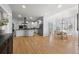 Open-concept kitchen featuring white cabinets, a center island with seating, and a dining area at 404 Yarrow Pl, Castle Pines, CO 80108