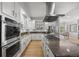 Modern kitchen showcasing stainless steel appliances, a gas cooktop, and granite countertops at 404 Yarrow Pl, Castle Pines, CO 80108