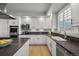 Well-appointed kitchen featuring a peninsula island with cooktop and stainless steel appliances at 404 Yarrow Pl, Castle Pines, CO 80108
