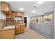 Basement kitchenette area features wood cabinets, decorative tile backsplash, and gray built-in display shelving at 404 Yarrow Pl, Castle Pines, CO 80108