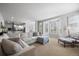 Bright and airy living room with neutral tones, comfortable seating, and a bay window at 404 Yarrow Pl, Castle Pines, CO 80108