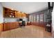 Bright office space with hardwood floors, custom wood built-ins, and natural light from a large window at 404 Yarrow Pl, Castle Pines, CO 80108