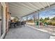 Large patio with dining table, and a blue chair seating area with firepit, for outdoor entertaining at 404 Yarrow Pl, Castle Pines, CO 80108