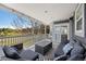 Covered porch with outdoor seating and views of the manicured yard at 404 Yarrow Pl, Castle Pines, CO 80108