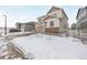 Two-story house with beige siding, stone accents, and a two-car garage at 5529 Gray Wolf Ln, Castle Rock, CO 80104