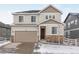 Two-story house with beige siding, stone accents, and a two-car garage at 5529 Gray Wolf Ln, Castle Rock, CO 80104