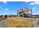 Expansive backyard featuring an outdoor kitchen, stone patio, fire pit, and well-kept lawn at 15322 Irving Ct, Broomfield, CO 80023