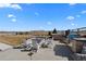 Well-maintained backyard with a stone fire pit, outdoor kitchen, hot tub and fenced perimeter at 15322 Irving Ct, Broomfield, CO 80023