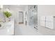 Bright bathroom featuring a glass shower, double vanity, and modern fixtures at 15322 Irving Ct, Broomfield, CO 80023