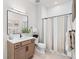 Well-lit bathroom featuring modern fixtures, a shower with stylish curtain and a vanity with storage at 15322 Irving Ct, Broomfield, CO 80023