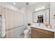Bright bathroom with a modern vanity, neutral shower curtain, and decorative accents at 15322 Irving Ct, Broomfield, CO 80023