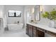 Bathtub and vanity in a spacious bathroom with plenty of natural light at 15322 Irving Ct, Broomfield, CO 80023
