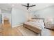 Inviting bedroom with a ceiling fan, hardwood floors, dresser, and soft blue walls at 15322 Irving Ct, Broomfield, CO 80023