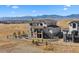 Stunning rear exterior showcasing a two-story home with a stone-clad walkout basement and mountain views at 15322 Irving Ct, Broomfield, CO 80023