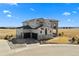 Stunning two-story stucco home with a three-car garage and beautifully landscaped front yard on a bright, sunny day at 15322 Irving Ct, Broomfield, CO 80023