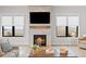 Cozy living room with a stone fireplace, wooden mantel, large windows, and natural light, creating a warm ambiance at 15322 Irving Ct, Broomfield, CO 80023