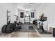 Bright home gym featuring weight training equipment, exercise bike, mirrors, and rubber flooring at 15322 Irving Ct, Broomfield, CO 80023