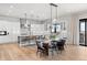 Bright, open kitchen featuring stainless steel appliances, white cabinets, and a dining area with pendant lighting at 15322 Irving Ct, Broomfield, CO 80023