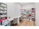 Bright office featuring custom shelves, two desks, and hardwood flooring at 15322 Irving Ct, Broomfield, CO 80023
