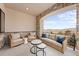 Relaxing outdoor patio area with wicker furniture, stone accents, and scenic views at 15322 Irving Ct, Broomfield, CO 80023