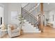 Elegant staircase featuring wooden steps, wrought iron spindles, and an open design leading to the entryway and living spaces at 15322 Irving Ct, Broomfield, CO 80023