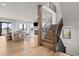 Elegant staircase with wooden steps, black metal railings, and an open floor plan leading to the living area at 15322 Irving Ct, Broomfield, CO 80023