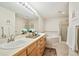 Bright bathroom featuring dual sinks, a large mirror, and a separate shower and soaking tub at 1767 N Pearl St # 308, Denver, CO 80203