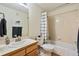 Clean bathroom featuring a shower-tub combo, wood vanity, and ample towel storage at 1767 N Pearl St # 308, Denver, CO 80203
