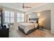Cozy bedroom with a ceiling fan, and a patterned rug under a well-lit bed and large window at 1767 N Pearl St # 308, Denver, CO 80203