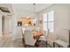 Cozy dining area featuring a round wood table, seating for four, and a view into the bright kitchen at 1767 N Pearl St # 308, Denver, CO 80203