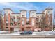 Modern brick apartment building with private garage, under a clear blue sky at 1767 N Pearl St # 308, Denver, CO 80203