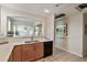 Bright kitchen featuring light wood cabinets, quartz countertops, black appliances, and neutral flooring at 1767 N Pearl St # 308, Denver, CO 80203