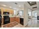 Kitchen with light wood cabinets, white countertops, and an opening looking into the living room at 1767 N Pearl St # 308, Denver, CO 80203