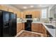 Modern kitchen with light wood cabinets, white countertops, and stainless steel appliances on tile flooring at 1767 N Pearl St # 308, Denver, CO 80203