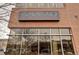 Exterior view of brick building with a 'Caveau Wine Bar' sign above a large window at 1767 N Pearl St # 308, Denver, CO 80203
