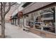 Charming storefront on a tree-lined street, featuring a bench and inviting display windows at 1767 N Pearl St # 308, Denver, CO 80203