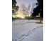 Snowy front yard with trees and building in background at 7755 E Quincy Ave # 107, Denver, CO 80237